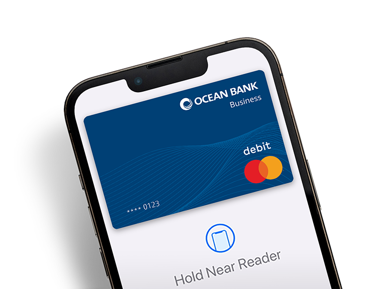 Ocean Bank debit card on screen of a smartphone with instructions to near a card reader to make a purchase.